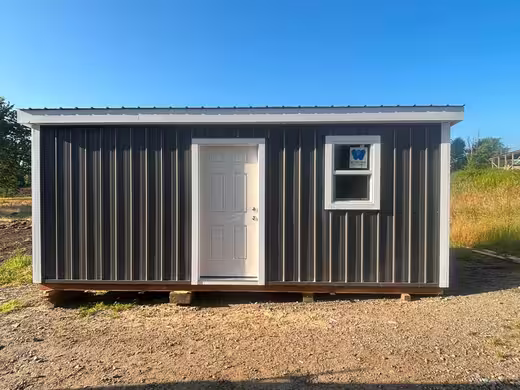 Charcoal shed with white trim, photo 1 of 3