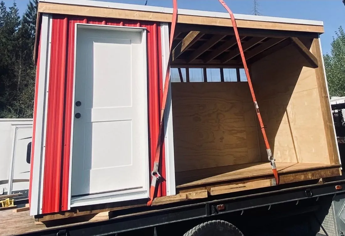 Shed being loaded onto a truck